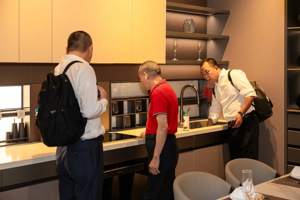 Guests explore cabinetry and kitchen solutions at the OPPEIN by BSQUARE showroom